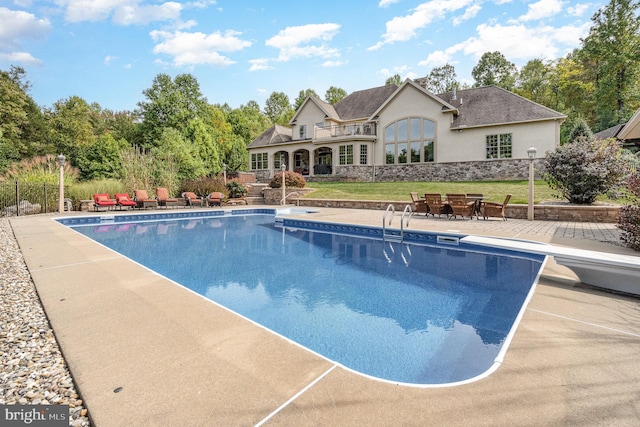 view of swimming pool featuring a fenced in pool, fence, a lawn, and a patio area