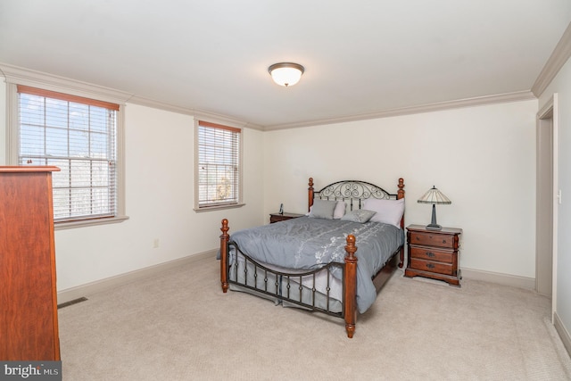 carpeted bedroom with visible vents, baseboards, and crown molding