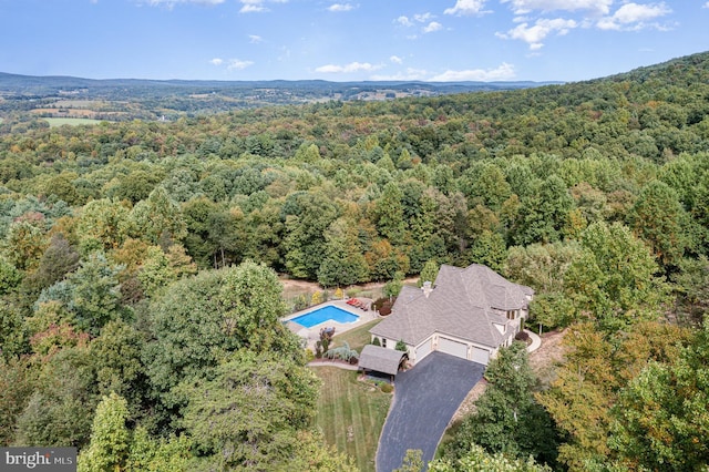 drone / aerial view featuring a forest view