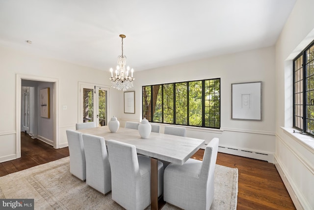 dining area featuring a healthy amount of sunlight, a chandelier, and dark hardwood / wood-style flooring