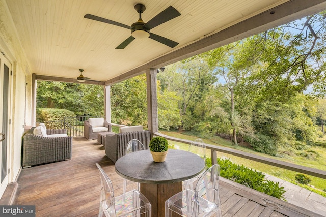 deck with an outdoor living space and ceiling fan