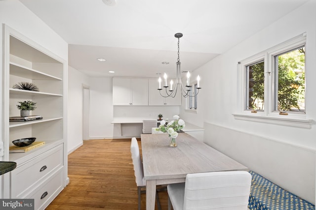 dining space featuring a notable chandelier and wood-type flooring