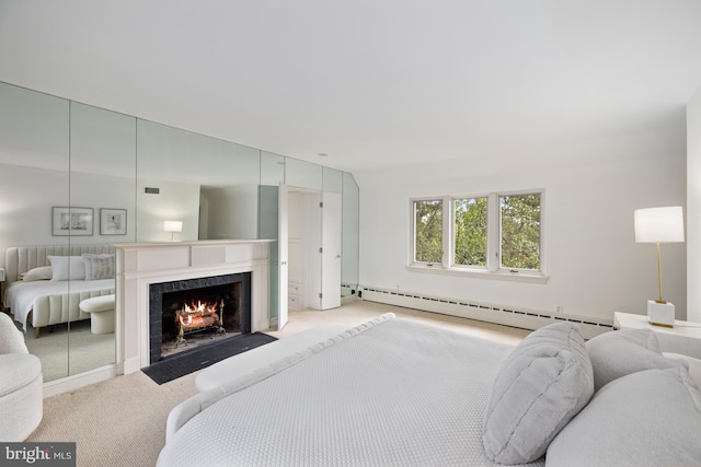 carpeted bedroom featuring a baseboard heating unit