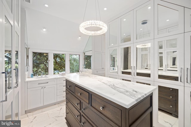 spacious closet with sink and high vaulted ceiling