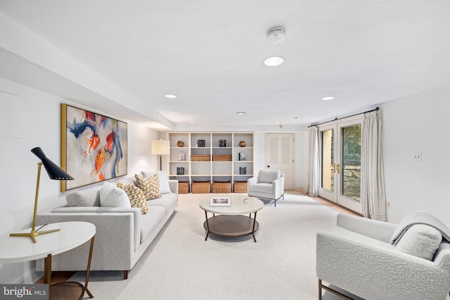 living room with french doors and carpet flooring