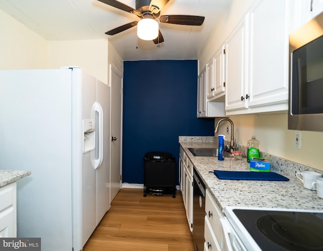 kitchen featuring white appliances, sink, light wood-type flooring, white cabinetry, and light stone counters