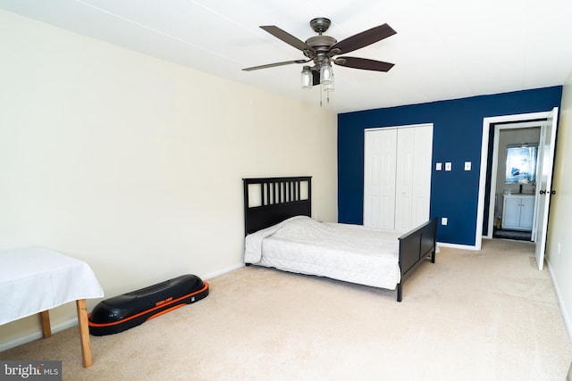 bedroom with a closet, ceiling fan, and light carpet