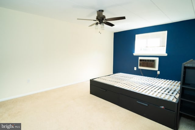 carpeted bedroom with ceiling fan and a wall unit AC