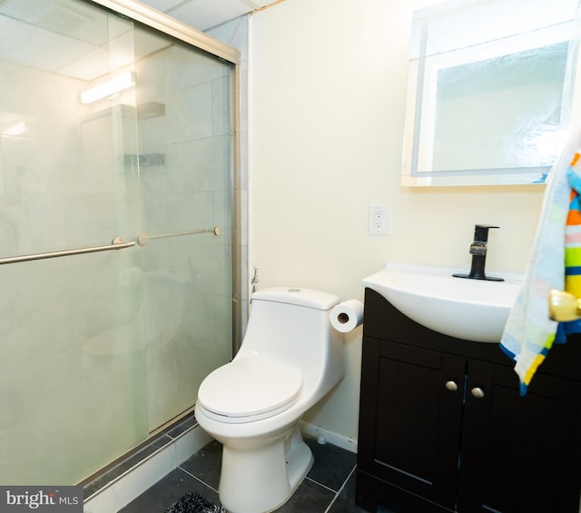 bathroom featuring vanity, tile patterned flooring, toilet, and a shower with door