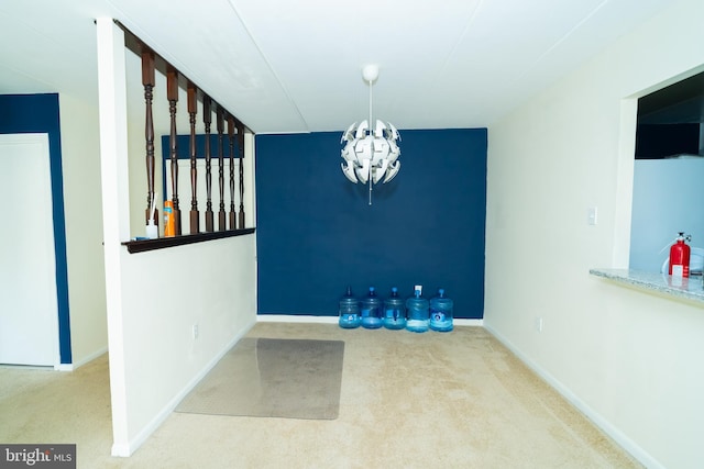 unfurnished dining area featuring a chandelier and carpet flooring