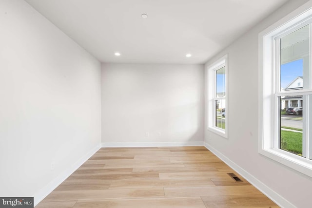 spare room featuring light hardwood / wood-style flooring