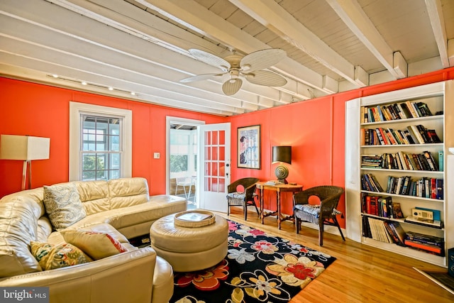 living room with beamed ceiling, hardwood / wood-style floors, french doors, and ceiling fan