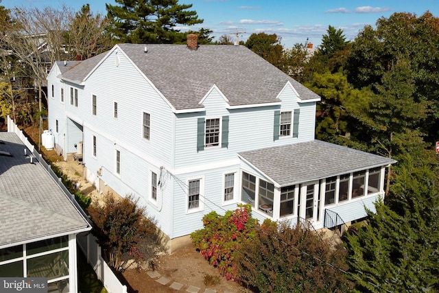 rear view of house featuring a sunroom