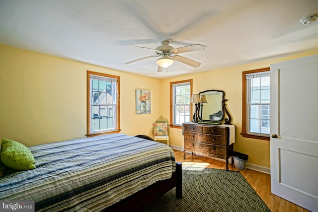 bedroom with ceiling fan and light hardwood / wood-style flooring