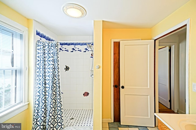 bathroom with vanity, a shower with curtain, and tile patterned flooring