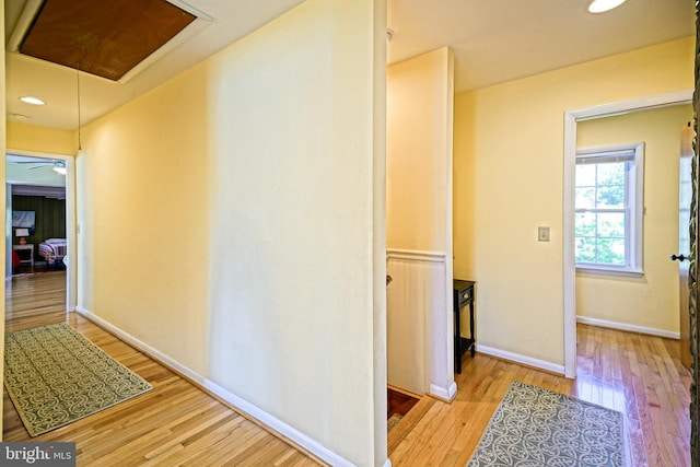 corridor with hardwood / wood-style flooring