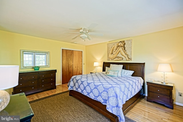 bedroom featuring a closet, wood-type flooring, and ceiling fan