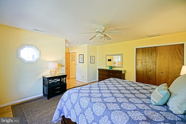 bedroom featuring hardwood / wood-style flooring, a closet, and ceiling fan