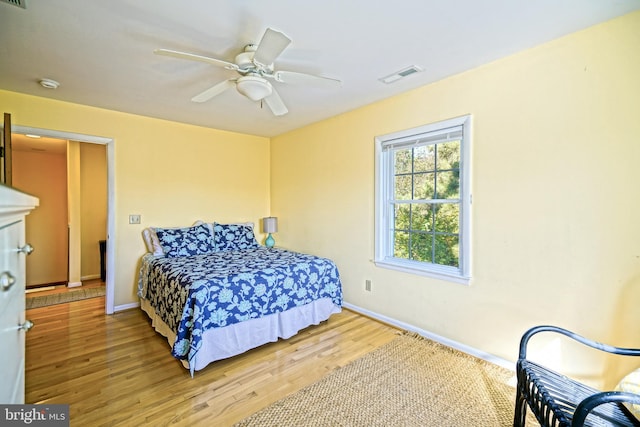 bedroom with hardwood / wood-style floors and ceiling fan