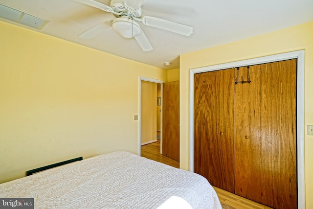 bedroom featuring a closet, light wood-type flooring, and ceiling fan