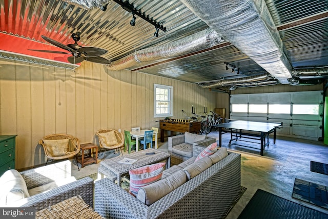 interior space with concrete floors and ceiling fan