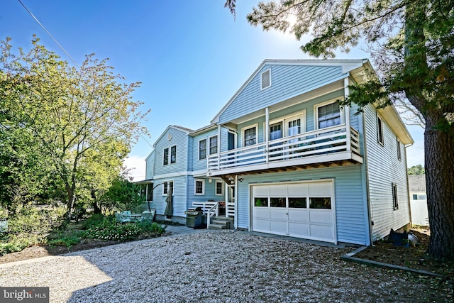 front of property featuring a balcony and a garage