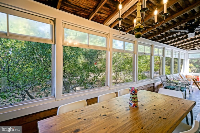 unfurnished sunroom with beam ceiling and wooden ceiling