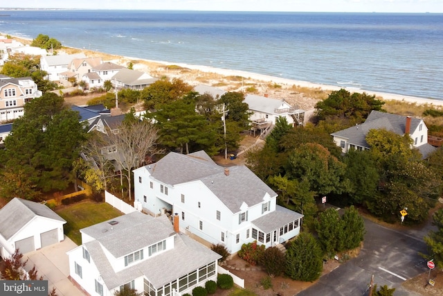 drone / aerial view featuring a water view and a beach view