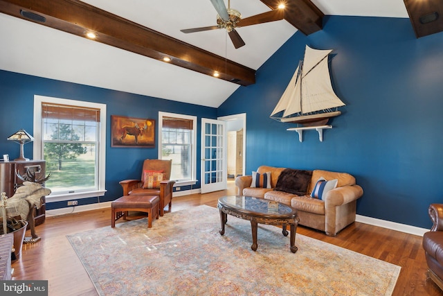 living room featuring hardwood / wood-style flooring, a healthy amount of sunlight, and lofted ceiling with beams