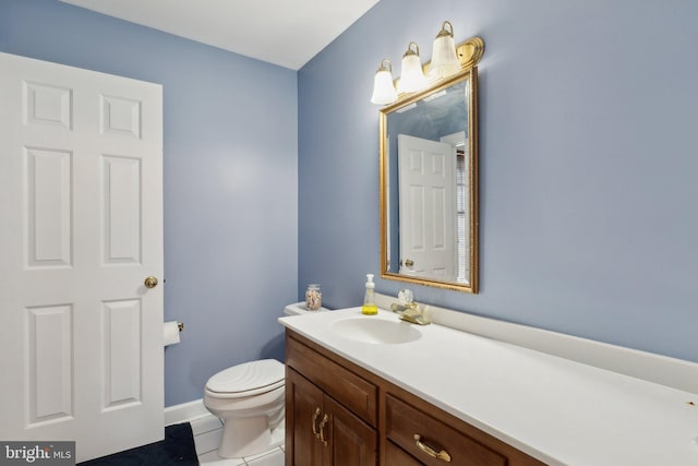 bathroom featuring vanity, toilet, and tile patterned floors