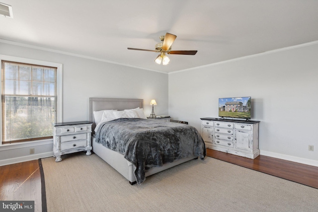 bedroom with ceiling fan, hardwood / wood-style flooring, and crown molding