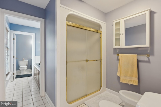 bathroom featuring a shower with door, toilet, tile patterned floors, and a bidet