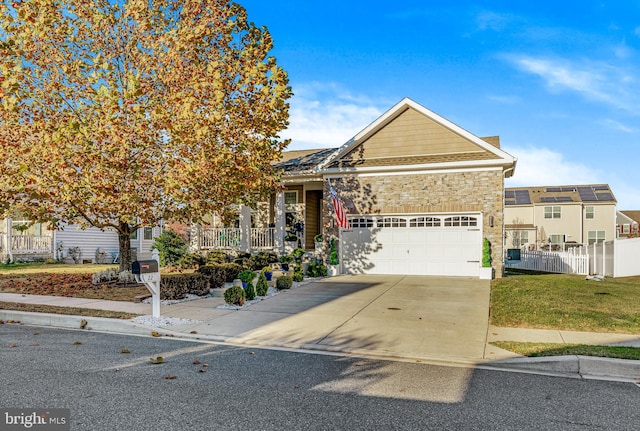 view of front of property featuring a front lawn and a garage