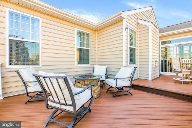 deck featuring an outdoor fire pit