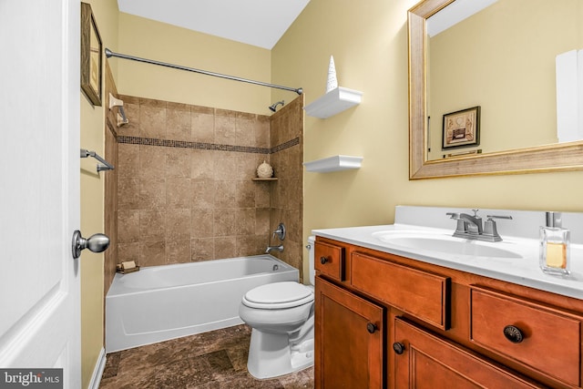 full bathroom with toilet, vanity, and tiled shower / bath