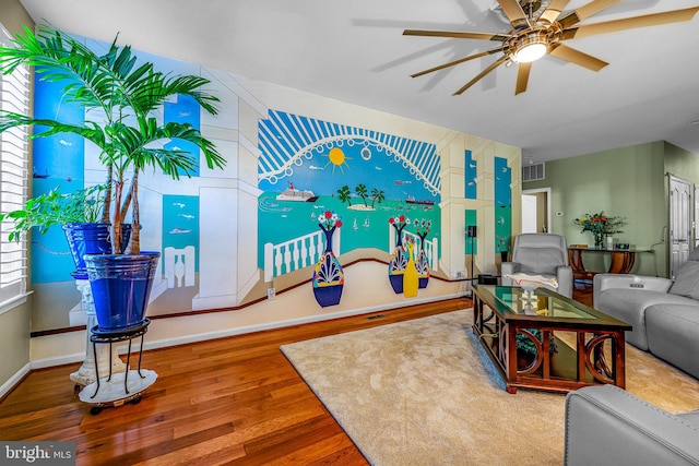 living room featuring wood-type flooring and ceiling fan