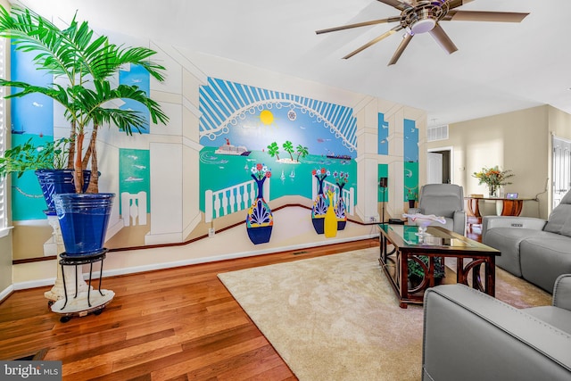 living room featuring hardwood / wood-style floors and ceiling fan