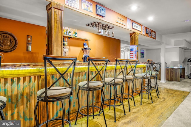 bar featuring light hardwood / wood-style flooring