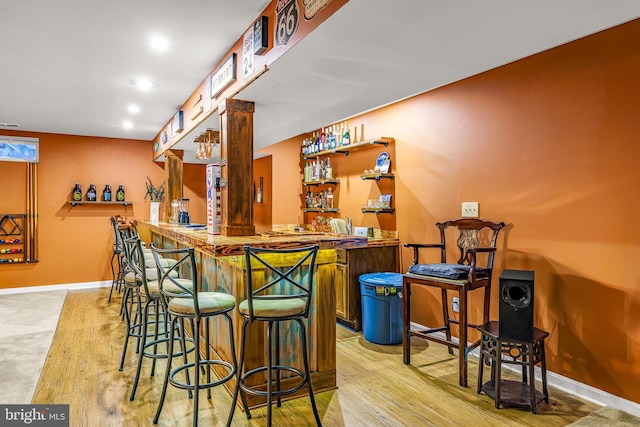 bar featuring light hardwood / wood-style flooring