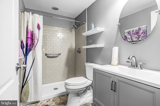 bathroom with curtained shower, vanity, and toilet