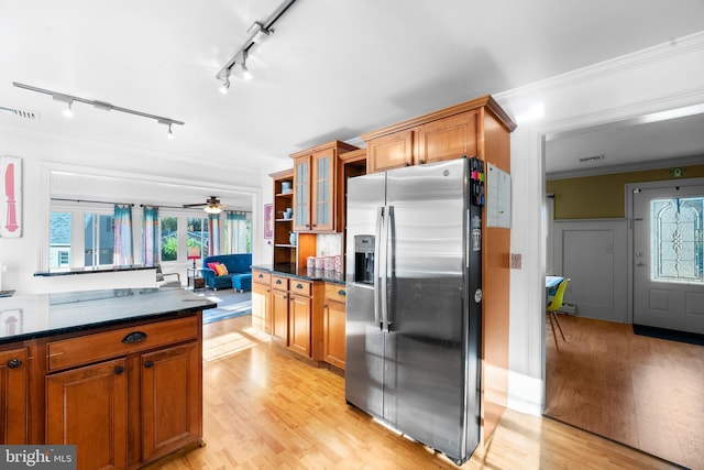 kitchen featuring a wealth of natural light, light wood-type flooring, and stainless steel fridge with ice dispenser