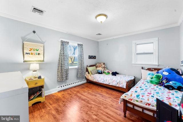 bedroom with baseboard heating, ornamental molding, and hardwood / wood-style flooring