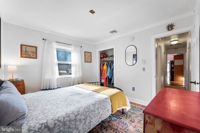 bedroom with a closet and crown molding