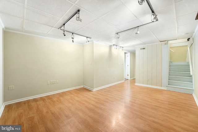 unfurnished room with ornamental molding, wood-type flooring, and rail lighting