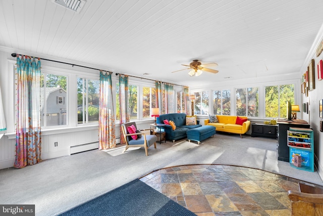 sunroom / solarium with a baseboard heating unit and ceiling fan