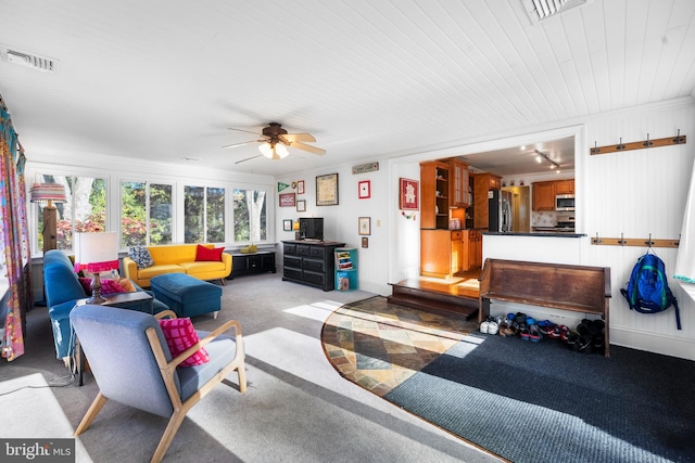 living room with light colored carpet and ceiling fan