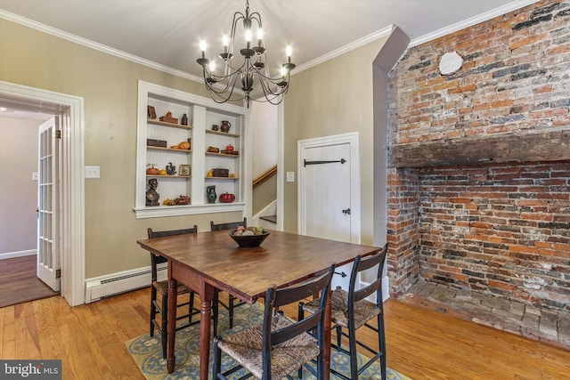 dining room with a baseboard radiator, crown molding, a notable chandelier, and light wood-type flooring