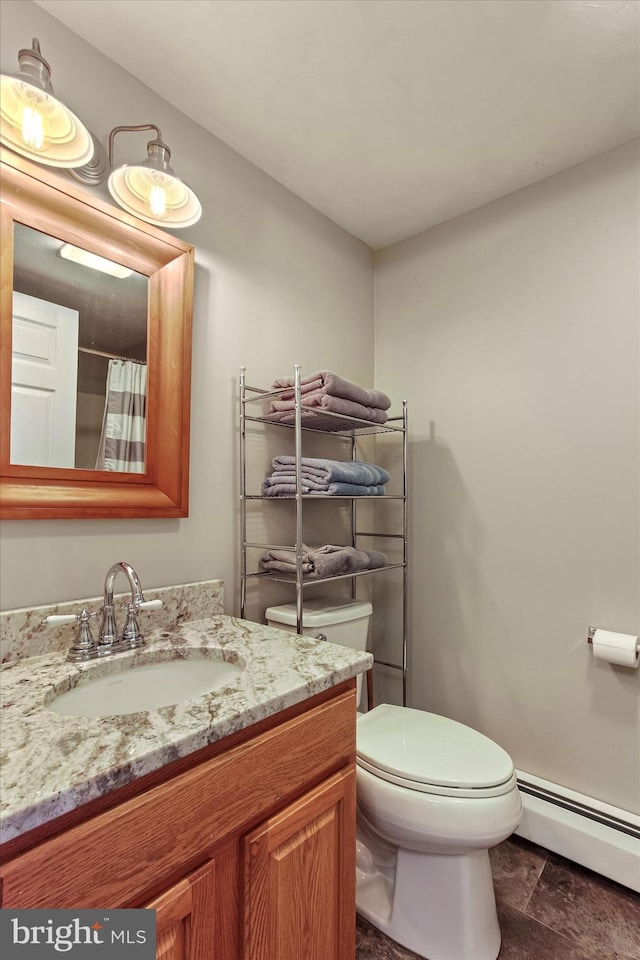 bathroom with vanity, a baseboard heating unit, and toilet