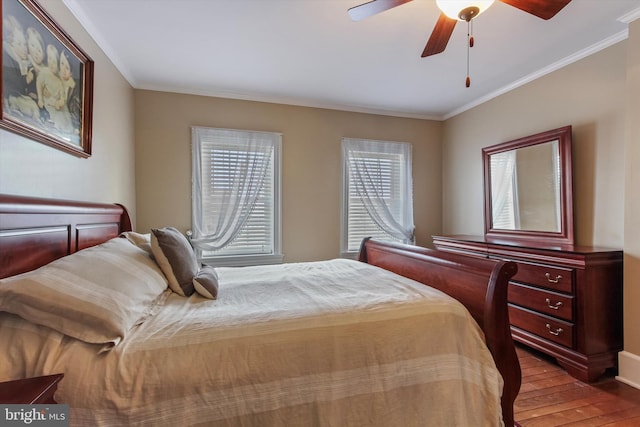 bedroom with ornamental molding, wood-type flooring, and ceiling fan