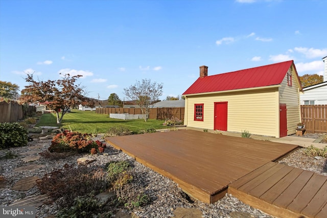 deck featuring a yard and an outbuilding